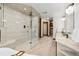 Spacious primary bathroom featuring a walk-in glass shower, double vanity, and wood-trim accents at 9303 Dauntless Way, Conifer, CO 80433
