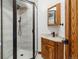 Bathroom featuring a glass walk-in shower, marble vanity, and wood-trimmed accents at 9303 Dauntless Way, Conifer, CO 80433