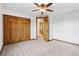Bedroom featuring wood-trimmed accents, a closet with sliding doors, and carpeted floors at 9303 Dauntless Way, Conifer, CO 80433