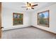 Bright and airy bedroom with natural light, two windows with backyard views, and neutral carpet at 9303 Dauntless Way, Conifer, CO 80433