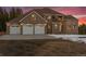 Inviting brick home features a three-car garage and ample parking space at 9303 Dauntless Way, Conifer, CO 80433