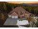 Majestic brick home boasts mountain views, a three-car garage, and a sprawling driveway at 9303 Dauntless Way, Conifer, CO 80433