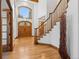 Stunning entryway showcases a wood staircase, beautiful wood floors, and a grand front door at 9303 Dauntless Way, Conifer, CO 80433