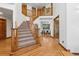 Grand foyer with hardwood floors, elegant staircase, and view into the dining area at 9303 Dauntless Way, Conifer, CO 80433