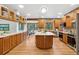 Expansive kitchen with wood cabinetry, stone backsplash and an island with bar seating at 9303 Dauntless Way, Conifer, CO 80433
