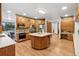 Stylish kitchen featuring stone walls, wood cabinetry, and a center island with wine storage at 9303 Dauntless Way, Conifer, CO 80433