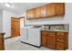 Practical laundry room equipped with a sink, countertop space, and wooden cabinets for storage at 9303 Dauntless Way, Conifer, CO 80433