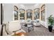 Bright living room features large windows, neutral decor, and a cozy atmosphere at 9303 Dauntless Way, Conifer, CO 80433