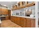 Bright room featuring a brick fireplace, wooden cabinets and stone wall accents at 9303 Dauntless Way, Conifer, CO 80433