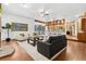 Inviting living room with hardwood floors, beamed ceilings, and views to the open kitchen at 9303 Dauntless Way, Conifer, CO 80433