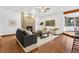 Comfortable living room with a brick fireplace, plush seating, and lots of natural light at 9303 Dauntless Way, Conifer, CO 80433