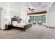 Spacious main bedroom with large window, ceiling fan, and cozy sitting area at 9303 Dauntless Way, Conifer, CO 80433