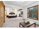 Open main bedroom featuring a sitting area, large window, and an attached bathroom at 9303 Dauntless Way, Conifer, CO 80433