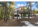 Outdoor playground structure with swings, climbing features, and surrounding natural landscape at 9303 Dauntless Way, Conifer, CO 80433