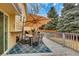 Back deck area featuring a dining table with umbrella and seating at 983 S Ouray St, Aurora, CO 80017