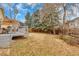 Large, leafy backyard with a deck, tall trees, and a wooden fence at 983 S Ouray St, Aurora, CO 80017