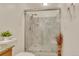 Bathroom featuring a glass shower door with marble tile surround and a tiled shower floor at 983 S Ouray St, Aurora, CO 80017