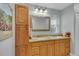 Bright bathroom featuring double vanity with granite countertop and wooden cabinet for ample storage at 983 S Ouray St, Aurora, CO 80017