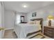 Bright bedroom featuring a large bed, wood-look flooring, and a dresser by the window at 983 S Ouray St, Aurora, CO 80017