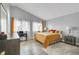 Spacious bedroom with a vaulted ceiling, wood flooring, and large windows for plenty of natural light at 983 S Ouray St, Aurora, CO 80017
