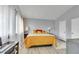 Bright bedroom with wood floors, vaulted ceiling, and natural light streaming through the sheer curtains at 983 S Ouray St, Aurora, CO 80017