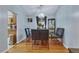 Dining room featuring modern chandelier, hardwood floors, and a view into the kitchen at 983 S Ouray St, Aurora, CO 80017