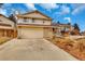 Charming two-story home with a brick facade, a two car garage, and a well kept lawn at 983 S Ouray St, Aurora, CO 80017