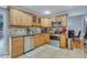 Modern kitchen equipped with stainless steel appliances, tile backsplash, and wood cabinetry at 983 S Ouray St, Aurora, CO 80017