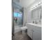 Bathroom with a shower-tub combo and white vanity, offering a clean and functional space at 10948 Murray Dr, Northglenn, CO 80233