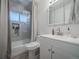 Bright bathroom featuring a shower and tub combination and a vanity with storage at 10948 Murray Dr, Northglenn, CO 80233