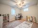 Bedroom with neutral walls, ceiling fan, and a workstation; quirky floor decor at 10948 Murray Dr, Northglenn, CO 80233