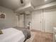 Well-lit bedroom showcasing carpet, a bed, and multiple closets and storage spaces at 10948 Murray Dr, Northglenn, CO 80233