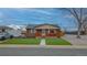 Charming brick home with a cozy front porch and well-manicured lawn at 10948 Murray Dr, Northglenn, CO 80233