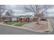 Charming brick home featuring a cozy front porch and manicured lawn at 10948 Murray Dr, Northglenn, CO 80233