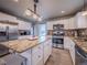 Kitchen featuring a large island with granite countertops, stainless steel appliances, and white cabinets at 10948 Murray Dr, Northglenn, CO 80233