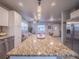 Open concept kitchen featuring a large island with granite countertop that overlooks the living area at 10948 Murray Dr, Northglenn, CO 80233