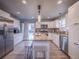 Modern kitchen with stainless appliances, granite countertops and island seating at 10948 Murray Dr, Northglenn, CO 80233