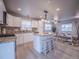 Open kitchen with modern appliances and an island with barstool seating at 10948 Murray Dr, Northglenn, CO 80233