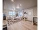 Bright living room features modern furniture, natural light, and a staircase at 10948 Murray Dr, Northglenn, CO 80233