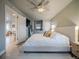Bright bedroom with neutral walls, large bed, and a view through to the living room at 10948 Murray Dr, Northglenn, CO 80233
