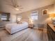 Cozy bedroom with a ceiling fan, two windows with woven shades, and modern decor at 10948 Murray Dr, Northglenn, CO 80233