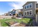 Landscaped backyard with a patio, garden boxes, and privacy fence at 723 176Th Ave, Broomfield, CO 80023