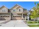 Charming two-story home with a well-manicured lawn and a welcoming front porch on a bright, sunny day at 723 176Th Ave, Broomfield, CO 80023