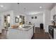 Spacious kitchen island with a granite countertop that connects to the dining area with hardwood flooring at 723 176Th Ave, Broomfield, CO 80023
