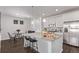 Modern kitchen with granite counters, stainless appliances, white cabinets, and a spacious island with bar seating is ready to enjoy at 723 176Th Ave, Broomfield, CO 80023