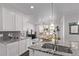 Open-concept kitchen with granite countertops, stainless steel appliances and a large island overlooks living area at 723 176Th Ave, Broomfield, CO 80023