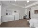 A view of the main bedroom with carpet flooring and white furnishings, including a dresser and desk at 723 176Th Ave, Broomfield, CO 80023