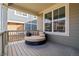 Relaxing covered porch featuring comfortable round wicker seating and neutral toned pillows at 723 176Th Ave, Broomfield, CO 80023
