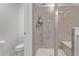 Modern tiled shower with a glass door and a built-in seat and shelving at 723 176Th Ave, Broomfield, CO 80023