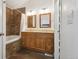 Bathroom with dual vanity, bath tub, shower with granite accents, and decorative mirrors at 8588 Sweet Clover Way, Parker, CO 80134